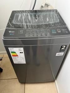 a washing machine is sitting on the floor at Dpto Bordemar 2 in Las Cruces
