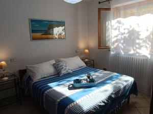 a bedroom with a bed with a suitcase on it at Appartamento nel parco in Marciana