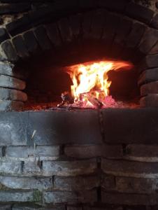 a brick oven with a fire in it at La Bruyère - B & B - in Tréban