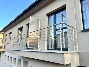 a balcony with a metal railing on a building at Apartmány Lucia in Poprad
