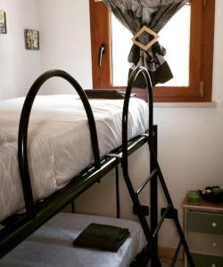 a bunk bed in a room with a window at Residenze Mquadro in Verona