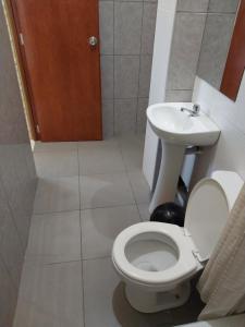 a bathroom with a toilet and a sink at Luz de Luna in Piura