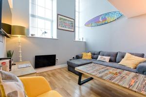 a living room with a couch and a table at Let's go sea in Swansea