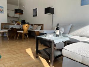 a living room with a couch and a table with wine glasses at Appartement Malejo am Hochkönig in Bachwinkl