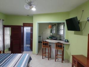 a bedroom with a bed and a kitchen with a sink at Casa Caribe in Bacalar