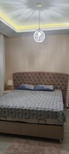 a bedroom with a large bed with a large headboard at Apartment in Antalya Konyaaltı in Antalya
