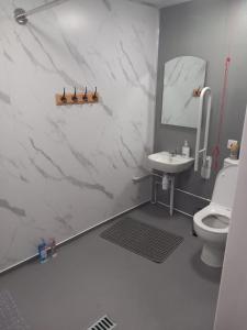 a white bathroom with a sink and a toilet at The Hive Great Yarmouth in Great Yarmouth