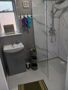 a bathroom with a shower and a sink at The Hive Great Yarmouth in Great Yarmouth