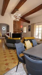 a living room with couches and a table and chairs at Propriété pour vous seul, vos amis et famille in Le Muy