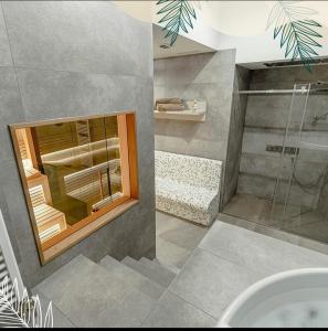 a bathroom with a shower and a glass window at Apartman Drvorez Jahorina in Jahorina