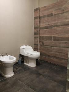 a bathroom with a toilet and a bidet at Apart Trelew in Trelew