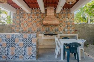 a patio with a table and chairs and a brick wall at Marysol private beach D12 next to nomads in Isla Mujeres
