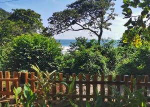 a wooden fence with a view of the beach at Lagarza Hostel in La Libertad
