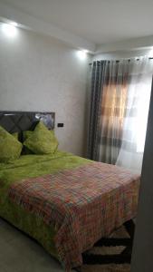 En eller flere senge i et værelse på Appartement de luxe