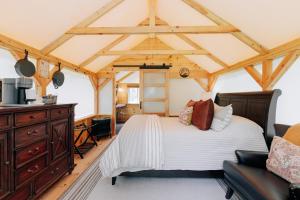 a bedroom with a bed and a wooden ceiling at The Preserve Battenkill River in Cambridge