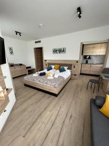 a large bedroom with a bed and a couch at Dani Wellness Apartman in Zalakaros