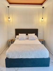 a bedroom with a bed with two night stands at La Villa del Sastre in Vélez-Málaga