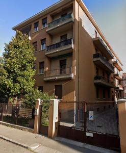 an apartment building with a fence in front of it at Casa Meo in Bologna