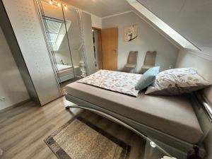 a bed in a small room with a mirror at Ferienwohnung auf dem Fels in Kall