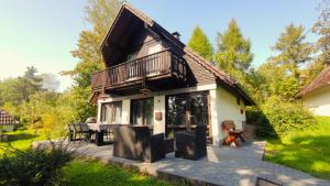 a house with a balcony and a patio at Ferienhaus Laange in Frankenau