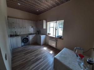 a room with a kitchen with a wooden floor at Nabran Suite in Aşağıoba
