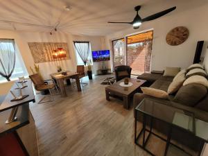 a living room with a couch and a table at Penthouse-Apartment AM KORNFELD in Lünen