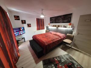 a bedroom with a bed and a television in it at Penthouse-Apartment AM KORNFELD in Lünen