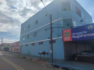 a blue building with a car parked in front of it at AP+preço popular+ar condicionado+internet 300mb in Goiânia