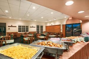 a restaurant with several trays of food on tables at Caribe Hotel Ponce in Ponce