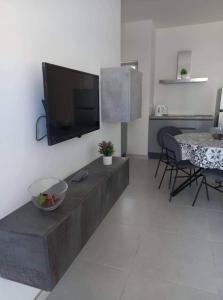 a living room with a flat screen tv on a wall at Sunquest court in St Paul's Bay