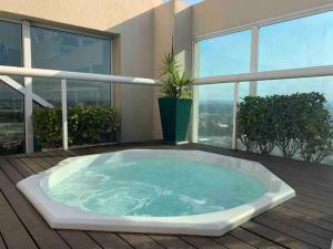 a jacuzzi tub on a deck in a building at SEQ - Sequoia Alphaville By Anora Spaces in Barueri