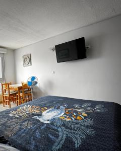 a bedroom with a bed with a bedspread with a bird on it at Studio cosy climatisé vue sur port in Cap d'Agde