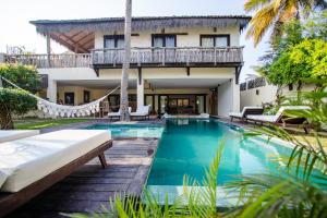 a villa with a swimming pool and a house at Casa Elea in Jericoacoara