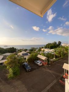 a view of a parking lot with cars parked at Ananas Premium in La Trinité