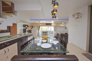 a kitchen with a table with dishes on it at shubh villa 4bhk in Lonavala