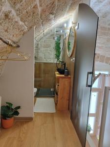a hallway with a door to a room with a brick wall at Alle volte Maison deluxe in Giovinazzo +108 photos