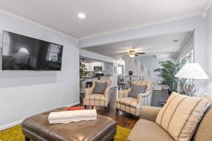 a living room with a couch and chairs and a tv at The Bamboo House! Dog-Friendly Home n RVA Sleeps 8 in Richmond