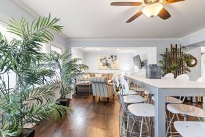 a dining room with plants and a ceiling fan at The Bamboo House! Dog-Friendly Home n RVA Sleeps 8 in Richmond