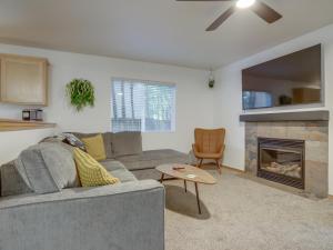 a living room with a couch and a fireplace at Twinberry Retreat - Meredith Lodging in Welches