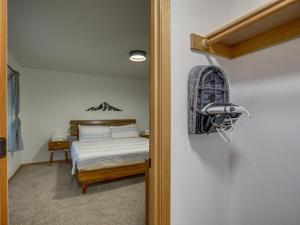 a bedroom with a bed and a door leading into a room at Twinberry Retreat - Meredith Lodging in Welches +47 photos