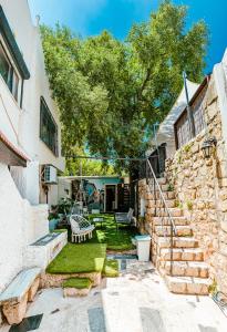 a stone house with a yard with a swing at Maim Haim Tzfat - Boutique Suites Prime location Old City Tzfat in Safed