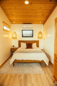 a bedroom with a bed and a wooden ceiling at The Lodge at 58* North in King Salmon