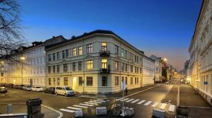 a large white building on a city street at night at Spacious & stylish apartment in Oslo - Supercentral in Oslo