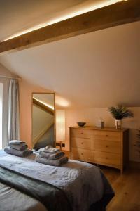 a bedroom with a large bed and a large mirror at Cedar Cottage in Eckington