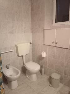 a bathroom with a toilet and a bidet at To Spitaki 