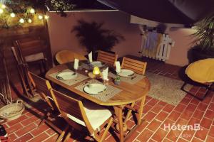 a wooden table and chairs in a room at Natural Escape Air-Conditioned T2 BIS Pools and Private Estate in Fitou! in Fitou