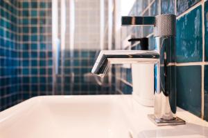 a bathroom sink with a faucet on top of it at House Mateja Unije in Unije