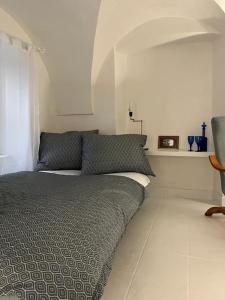 a bedroom with a bed and a window and a chair at city center Santorín in Banská Bystrica