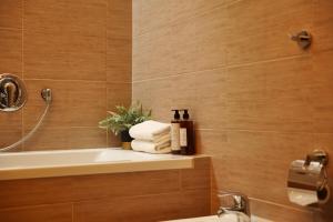 een badkamer met een bad, een wastafel en handdoeken bij Prague Castle King's Chic in Praag +45 foto's