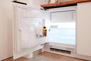 an empty refrigerator with its door open in a kitchen at House Mateja Unije in Unije